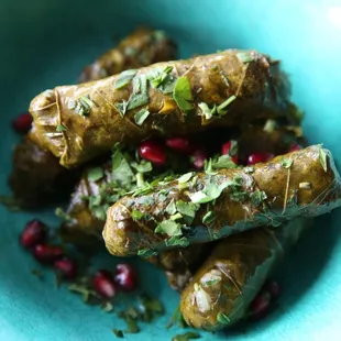 VEGAN DOLMA GRAPE LEAVES: rice, parsley, tomato, and olive oil