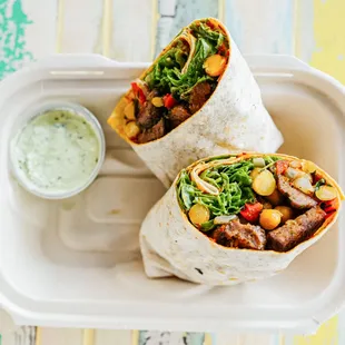 Butcher&apos;s Kofte (Meatball) Wrap. Comes with fresh herbs yogurt sauce and hot sauce.