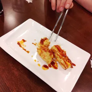 Complimentary sushi appetizer. Crab, cream cheese, tempura