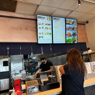a woman ordering food at a restaurant