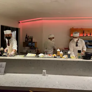 chefs preparing food in a restaurant
