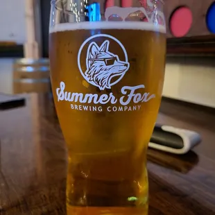 a glass of beer on a table