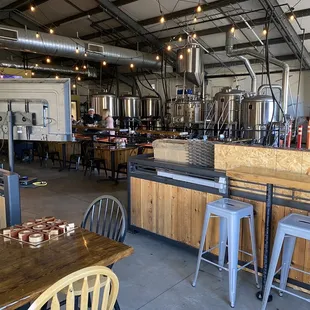 Lounge and game area near brewery tanks