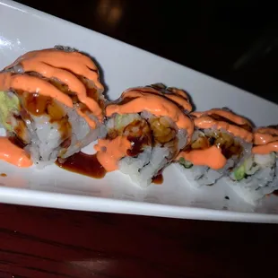 a plate of sushi with sauce
