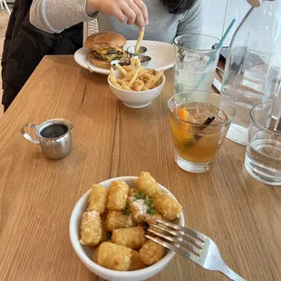 a woman sitting at a table with a plate of food