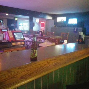 a bar with a bottle of beer on the counter