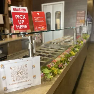a counter with a variety of frozen yogurt items