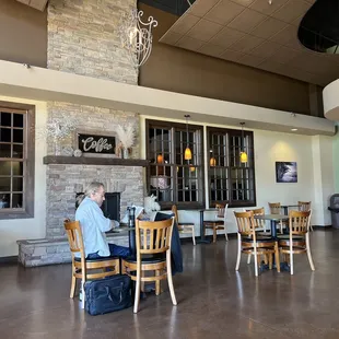 a man sitting at a table in a coffee shop