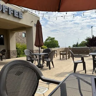 tables and chairs outside a coffee shop