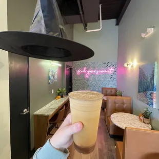 a hand holding a cup of coffee