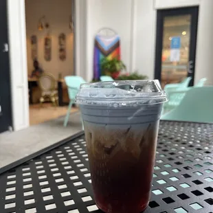 a cup of iced coffee on a table