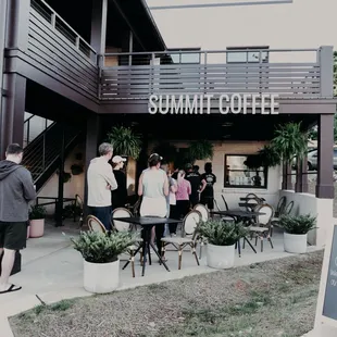 a group of people standing outside of a building