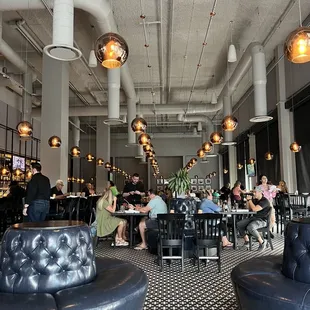 people sitting at tables in a restaurant