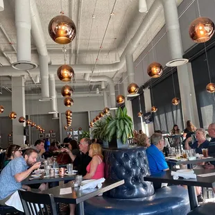 people sitting at tables in a restaurant
