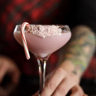 a woman holding a candy cane