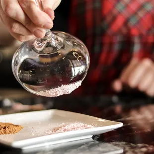 a person pouring wine into a glass