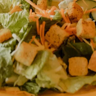 a salad with croutons and dressing