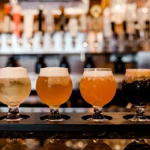 a row of beer glasses on a bar