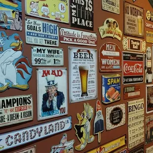 a wall full of beer signs