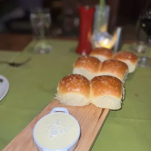 a table setting with rolls and dip