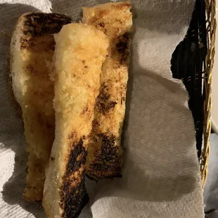 3 pieces of burnt bread on a paper towel