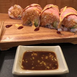 a sushi roll on a cutting board with chopsticks