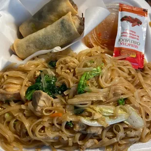 Noodle box with two beef noodle egg rolls
