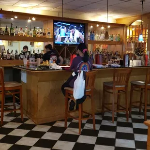 a woman sitting at the bar