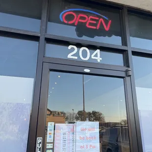 the open sign in the window
