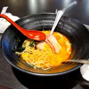 a bowl of ramen and a spoon