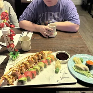 An Ohio roll, a Rainbow Roll, some white tuna and scallop sashimi, and some fish egg sushi.