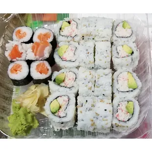 a variety of sushi in a plastic container