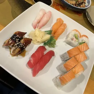 a variety of sushi on a white plate