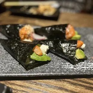 three pieces of sushi on a plate