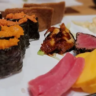 various types of sushi on a plate