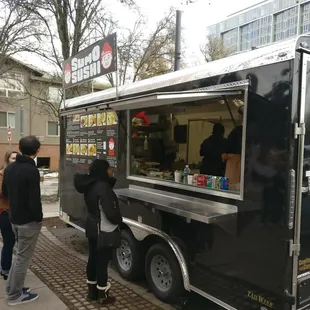 a man ordering food from a food truck