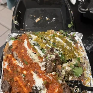 Half nacho half fries with asada green and red salsa !!