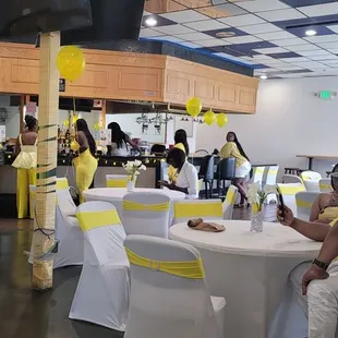 a group of people sitting at tables in a restaurant