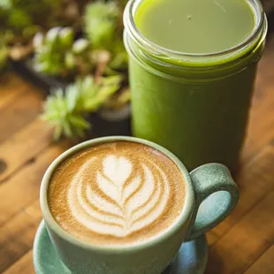 a cup of coffee and a jar of green juice