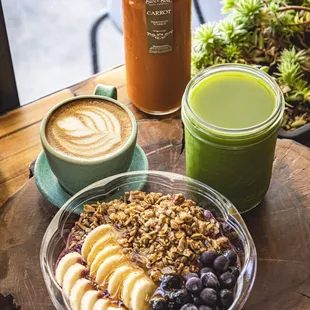 a bowl of oatmeal, bananas, and blueberries