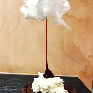 We call this the cloud dessert. Double chocolate tart with caramel, whipped cream, candied hazelnut and white cotton candy