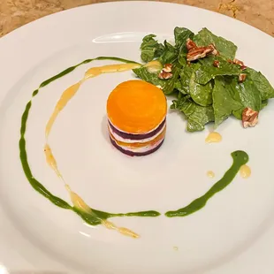 Roasted beet napoleon with goat cheese, baby spinach salad with toasted pecans and an orange sherry vinaigrette, basil oil drizzle