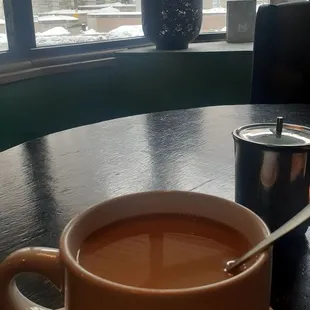 Enjoying a hot beverage.