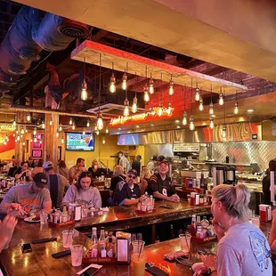 a large group of people sitting at a bar