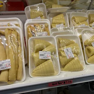 bananas in plastic containers on a shelf