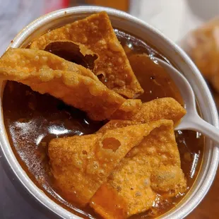 a bowl of soup with tortillas