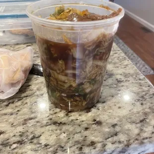 a plastic cup of soup