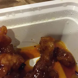 Insult to injury after eating a few bites I discovered this...Yes thats a hair wrapped around that piece. Absolutely disgusting.
