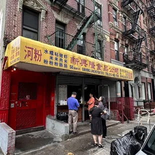 a group of people standing in front of a building