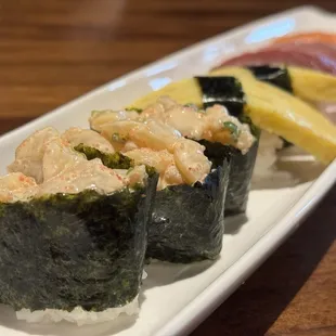 three sushi rolls on a plate